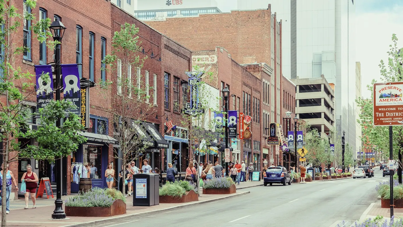 A brick-lined downtown street in Nashville, Tennessee, with shops and trees